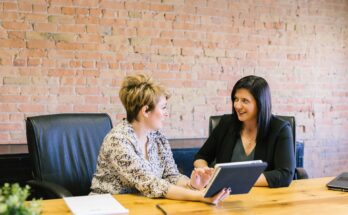 Business owner sitting at a desk with legal documents, receiving expert legal advice from a solicitor, representing the process of getting legal help for a small business