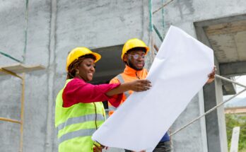 Construction workers on-site, collaborating on a building project, emphasizing teamwork, safety, and communication during the construction process