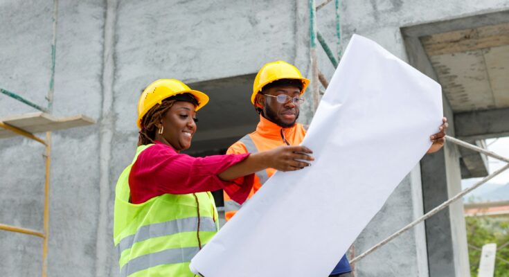 Construction workers on-site, collaborating on a building project, emphasizing teamwork, safety, and communication during the construction process