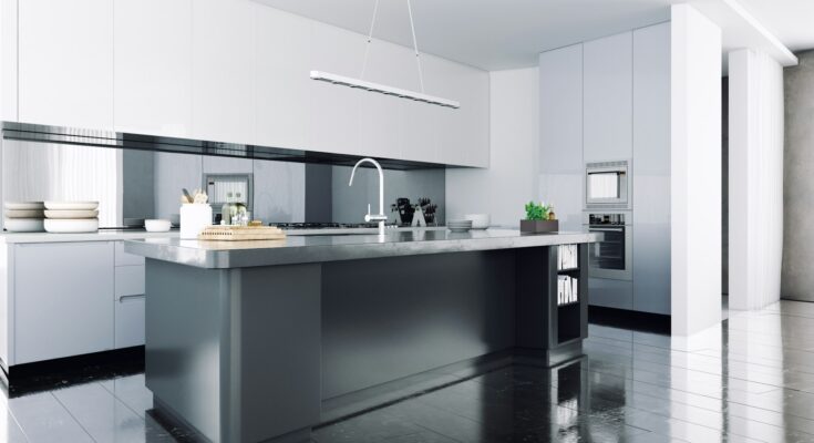 A modern kitchen island with sleek marble worktop, brass hardware, and pendant lighting above, featuring built-in kitchen cabinets for storage and comfortable bar stools for casual dining. The island is set in an open-plan kitchen with ample counter space and a harmonious colour scheme, creating a central hub for cooking, dining, and socializing.