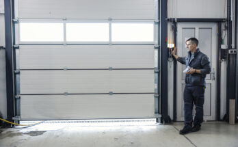 A garage door technician inspecting and repairing a residential garage door, ensuring proper alignment and smooth operation.