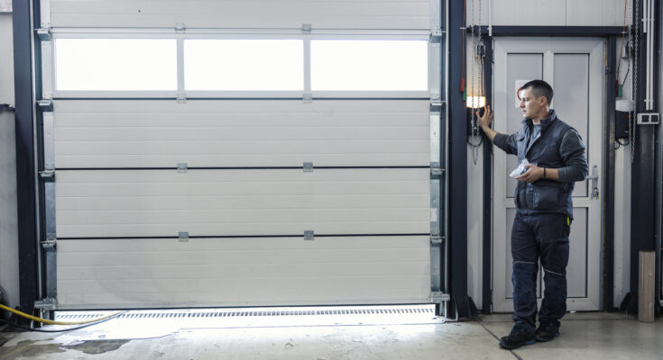A garage door technician inspecting and repairing a residential garage door, ensuring proper alignment and smooth operation.