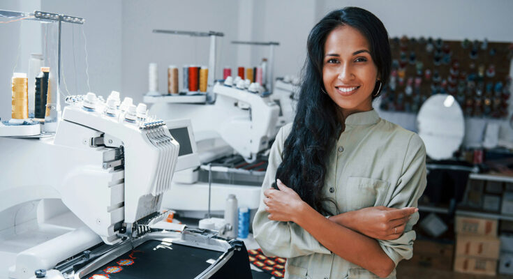 Worker operating embroidery machine — How to Get the Best Rate on Custom Embroidery